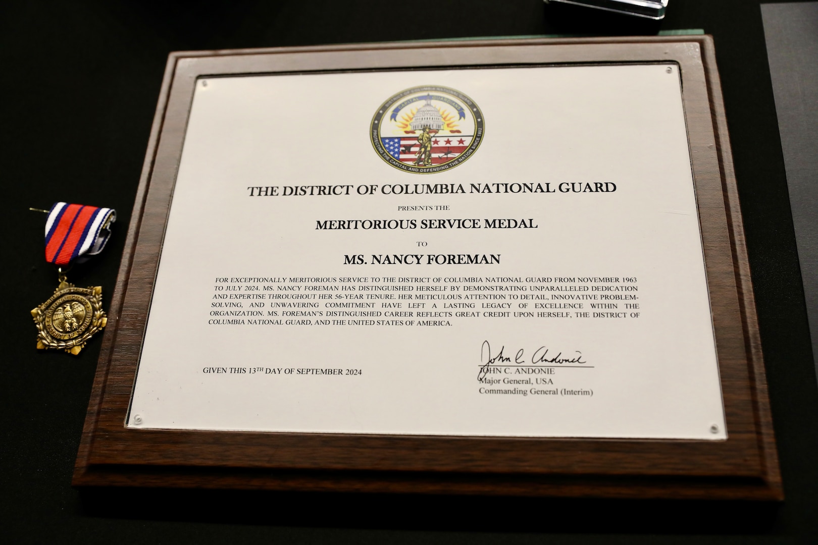 Ms. Nancy Foreman, administrative assistant, D.C. Government Operations-DCNG, retires after 56 years of service at the D.C. Armory, Sept. 13, 2024. The ceremony, officiated by Mr. Marcus Hunt, director, D.C. Govt. Ops-DCNG, included the presentation of the D.C. National Guard Meritorious Service Medal (MSM) by Maj. Gen. John C. Andonie, commanding general (Interim), D.C. National Guard, amongst other awards to include a retirement letter from Mayor Muriel Bowser for Foreman's support to military operational readiness, security and service to Washingtonians.