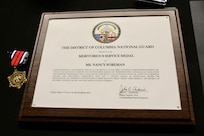 Ms. Nancy Foreman, administrative assistant, D.C. Government Operations-DCNG, retires after 56 years of service at the D.C. Armory, Sept. 13, 2024. The ceremony, officiated by Mr. Marcus Hunt, director, D.C. Govt. Ops-DCNG, included the presentation of the D.C. National Guard Meritorious Service Medal (MSM) by Maj. Gen. John C. Andonie, commanding general (Interim), D.C. National Guard, amongst other awards to include a retirement letter from Mayor Muriel Bowser for Foreman's support to military operational readiness, security and service to Washingtonians.