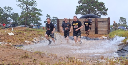 Soldiers run through an obstacle of the Marine Mud Challenge. Almost 700 participants showed up Sept. 14, 2024 to challenge their physical abilities to overcome and adapt to numerous obstacles on a four-mile course on Fort Eisenhower, Ga. as part of the Marine Mud Challenge.