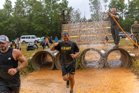 Maj. Gen. Ryan Janovic runs through an obstacle of the Marine Mud Challenge. Almost 700 participants showed up Sept. 14, 2024 to challenge their physical abilities to overcome and adapt to numerous obstacles on a four-mile course on Fort Eisenhower, Ga. as part of the Marine Mud Challenge.