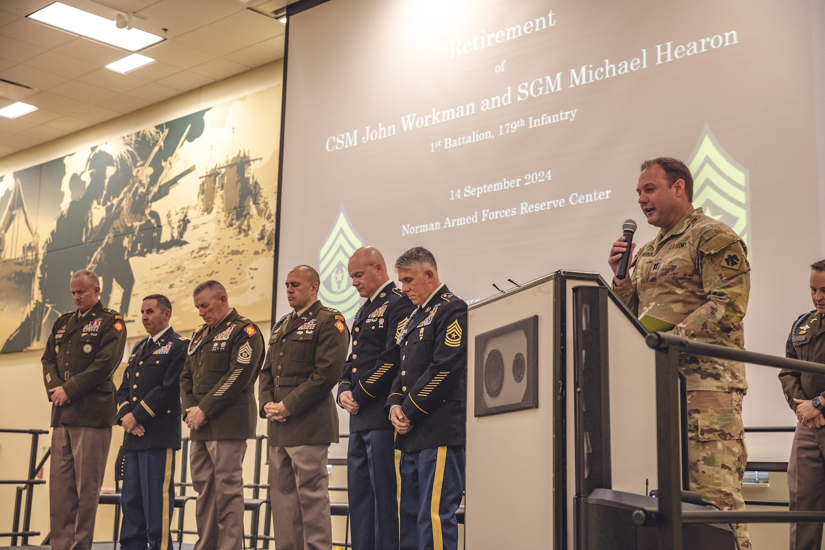 Brig. Gen. Colby Wyatt, director of the joint staff for the Oklahoma National Guard, speaks during a joint retirement ceremony for Command Sgt. Maj. John Workman of Glenpool, Oklahoma and Sgt. Maj. Michael Hearon of Mead, Oklahoma, both members of 1st Battalion, 179th Infantry Regiment, 45th Infantry Brigade Combat Team, held at the Norman Armed Forces Reserve Center in Norman, Oklahoma, Saturday, Sept. 14, 2024. Together Workman and Hearon have a combined 61 years of service, including their final assignment as members of the command team for Task Force Tomahawk during their deployment to the Horn of Africa from 2023-2024. (Oklahoma National Guard photo by Staff Sgt. Reece Heck)