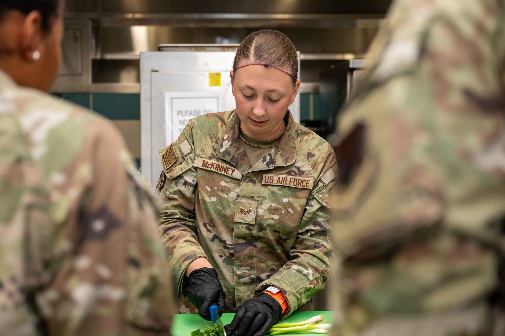 U.S. Air Force Senior Airman Kylie McKinney, 4th Security Forces Squadron assistant unit deployment manager, chops vegetables during the “Battle of the MSG” cooking competition at the Southern Eagle Dining Facility on Seymour Johnson Air Force Base, North Carolina, Aug. 22, 2024. The competition was hosted by the 4th Force Support Squadron and promoted camaraderie as well as allowed the participants to showcase their culinary skills. (U.S. Air Force photo by Airman 1st Class Rebecca Tierney)