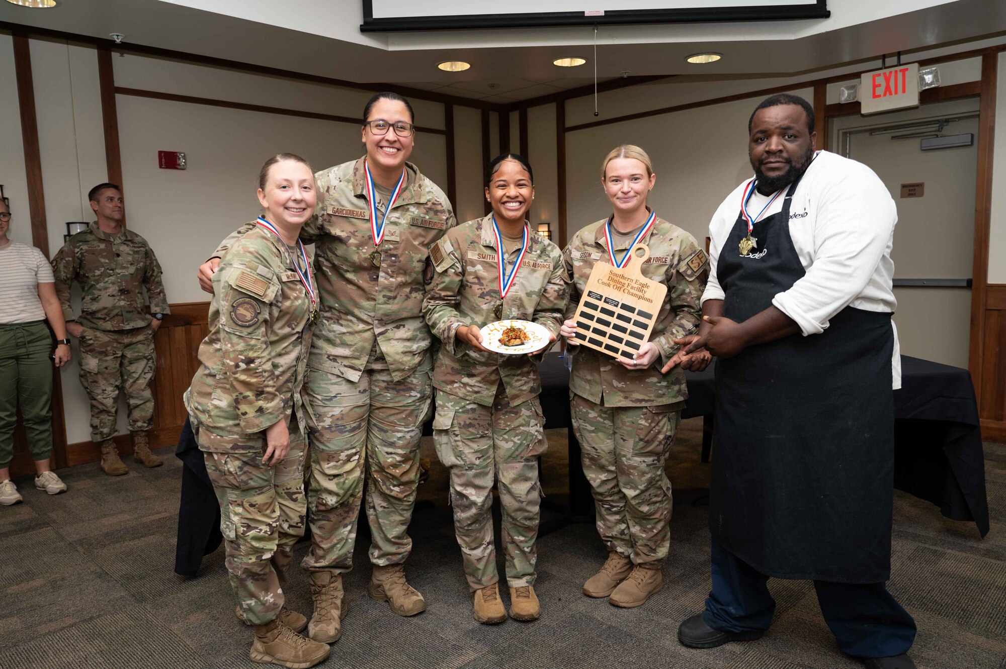 U.S. Air Force Airmen assigned to the 4th Security Forces Squadron pose with their medals during the “Battle of the MSG” cooking competition at the Southern Eagle Dining Facility on Seymour Johnson Air Force Base, North Carolina, Aug. 22, 2024. The competition was hosted by the 4th Force Support Squadron and promoted camaraderie as well as allowed the participants to showcase their culinary skills. (U.S. Air Force photo by Airman 1st Class Rebecca Tierney)