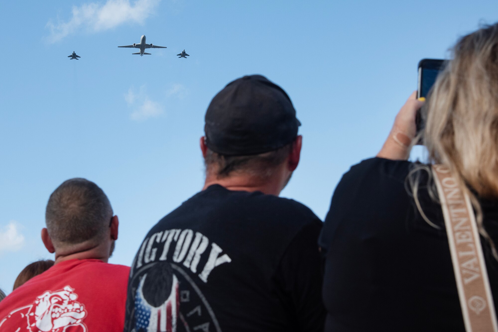 Spectators watch a three-ship flyover during the NC Freedom Fest 2024.