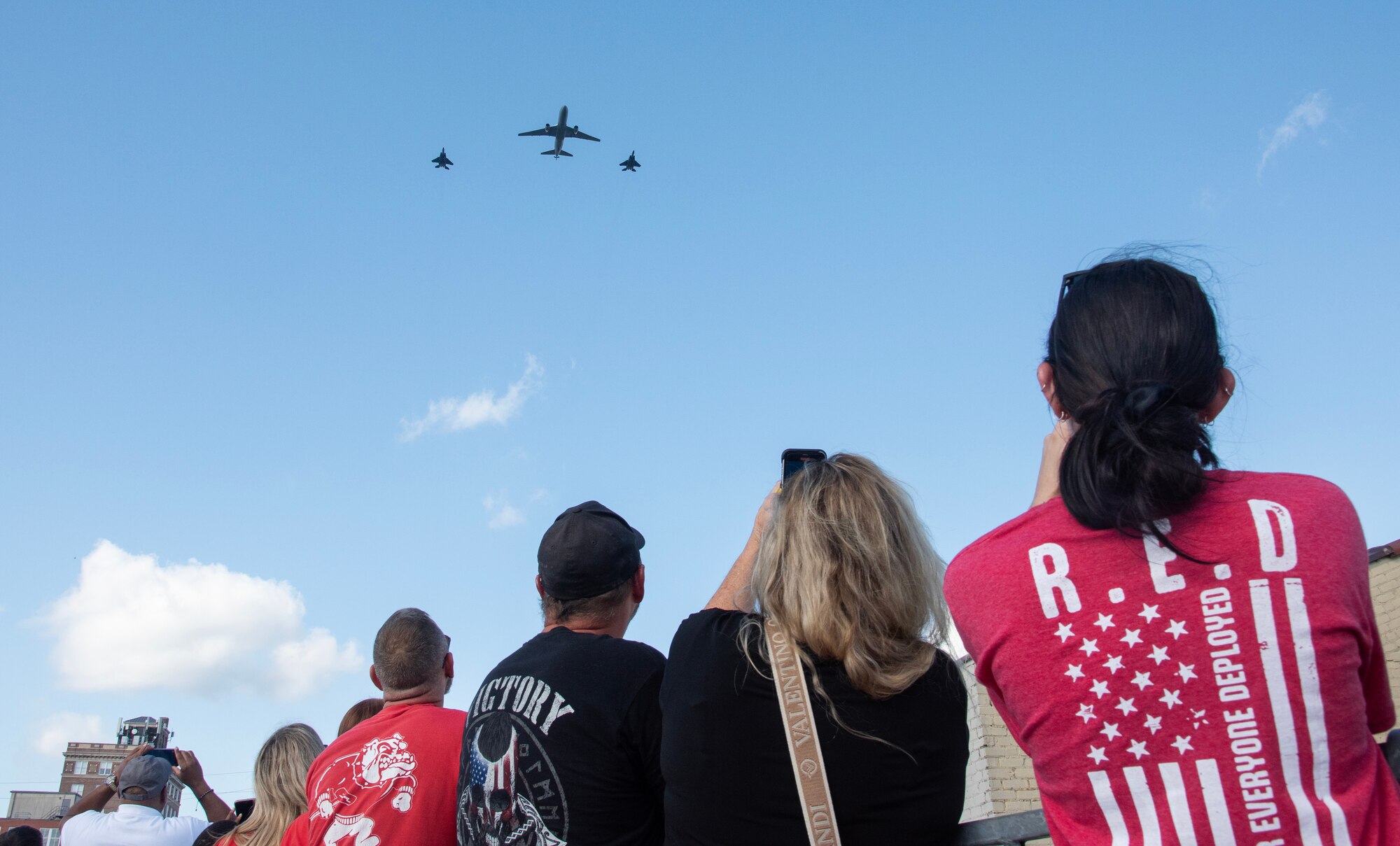 Spectators watch a three-ship flyover during the NC Freedom Fest 2024.