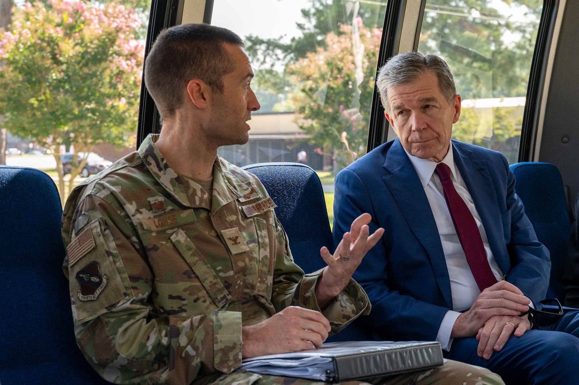 U.S. Air Force Col. Morgan Lohse, left, 4th Fighter Wing commander, converses with Governor Roy Cooper, right, Governor of North Carolina, during a congressional delegate visit at Seymour Johnson Air Force Base, North Carolina, Aug. 29, 2024. Cooper received a base tour and discussed topics such as quality of life for Airmen, childcare, and much more. (U.S. Air Force photo by Airman 1st Class Rebecca Tierney)