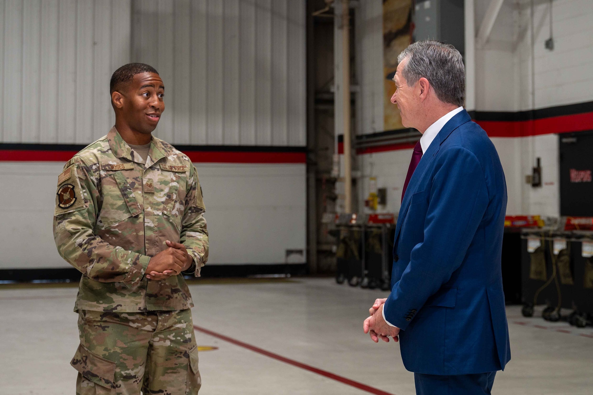 Governor Roy Cooper, Governor of North Carolina, converses with an Airman assigned to the 333rd Fighter Generation Squadron during a congressional delegate visit at Seymour Johnson Air Force Base, North Carolina, Aug. 29, 2024. Cooper received a brief regarding topics such as quality of life for Airmen, childcare, and much more. (U.S. Air Force photo by Airman 1st Class Rebecca Tierney)