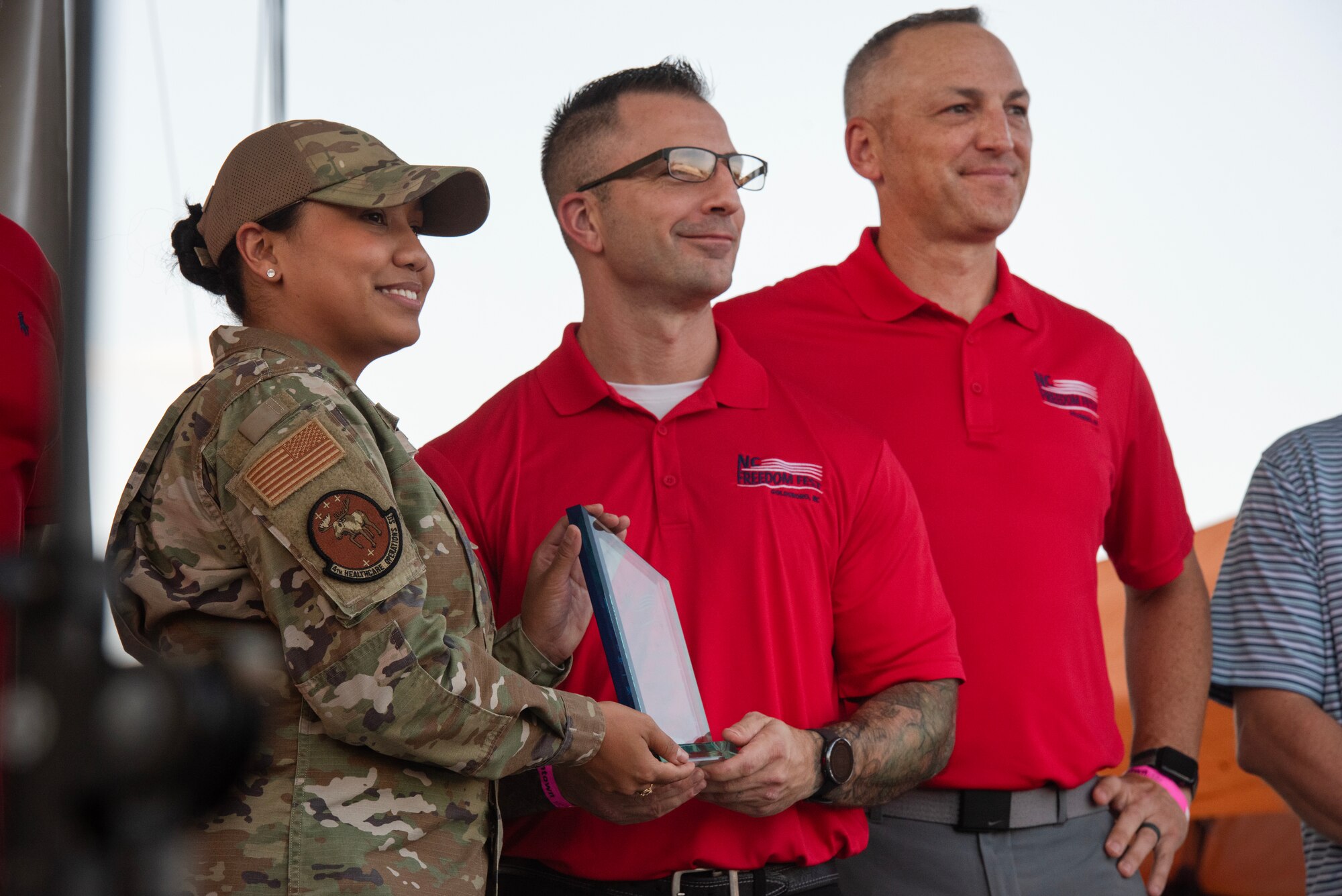 TSgt Sasha Chung, left, 4th HCOS, accepts the NCO of the Year Military Appreciation Award during the NC Freedom Fest 2024.