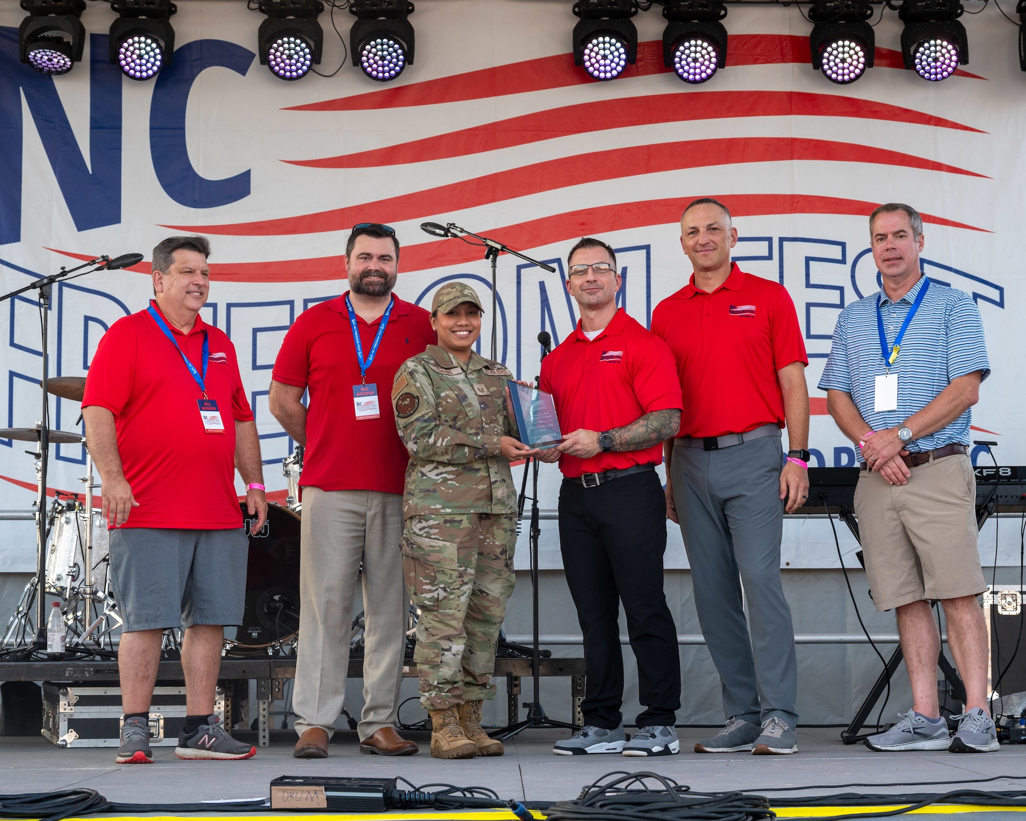 TSgt Sasha Chung, 4th HCOS, accepts the NCO of the Year Military Appreciation Award during Freedom Fest 2024.