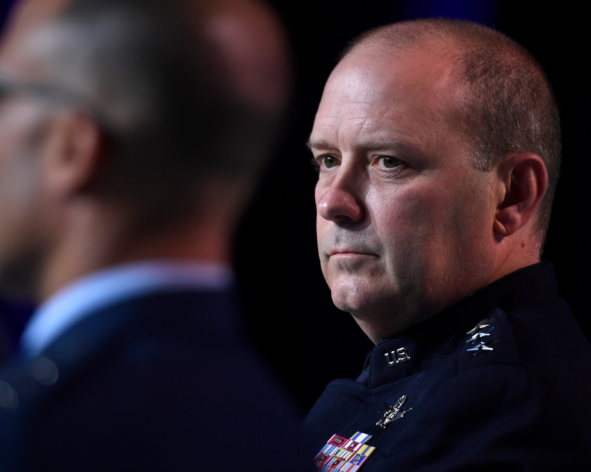 Two military generals speak at a conference panel