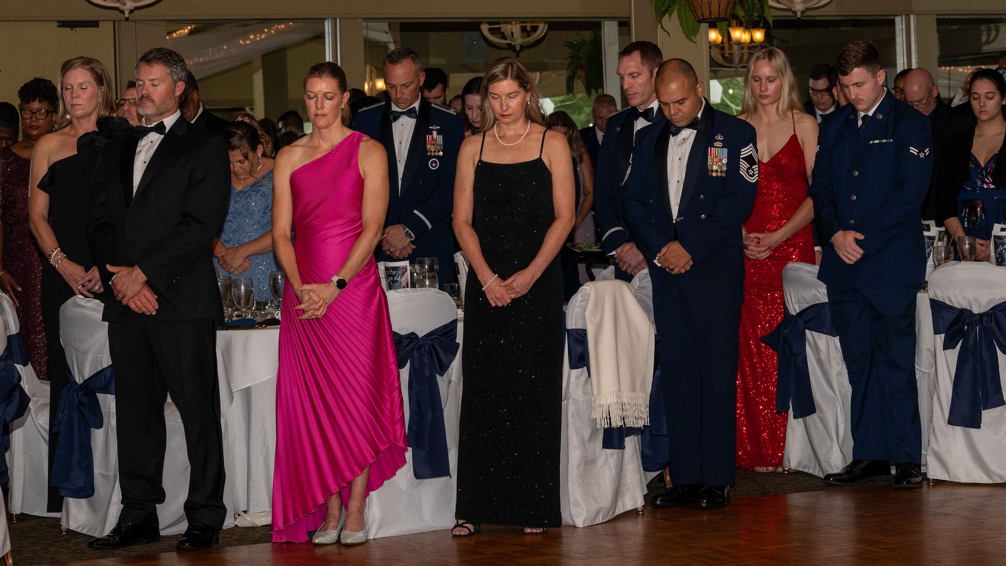 U.S. Air Force Airmen and their families engage in prayer during Seymour Johnson Air Force Base’s Ball at the Walnut Creek Country Club in Goldsboro, North Carolina, Sept. 14, 2024. The Air Force Ball is an annual event celebrating the anniversary of the Air Force becoming a separate service on Sept. 18, 1947. (U.S. Air Force photo by Airman 1st Rebecca Tierney)