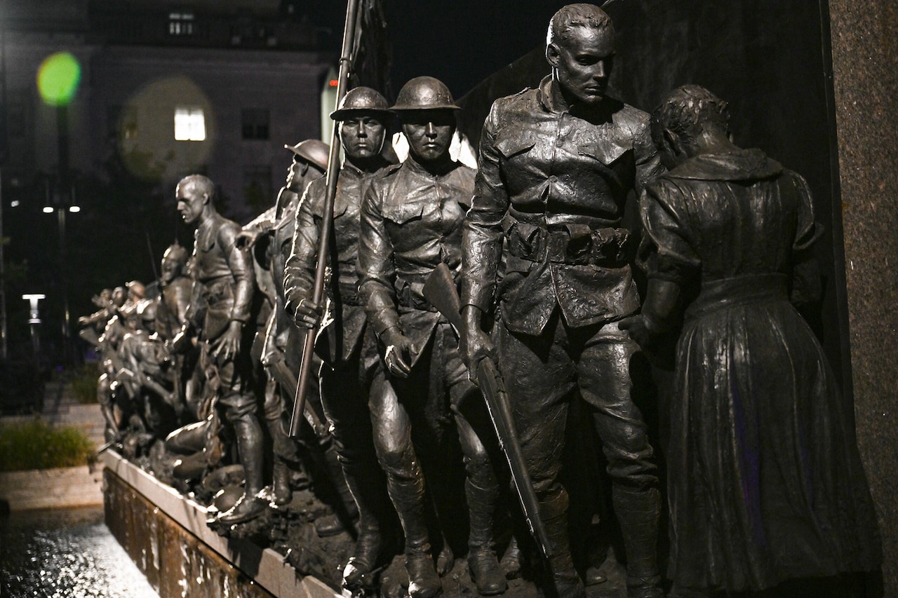 A sculpture depicts scenes from World War I.