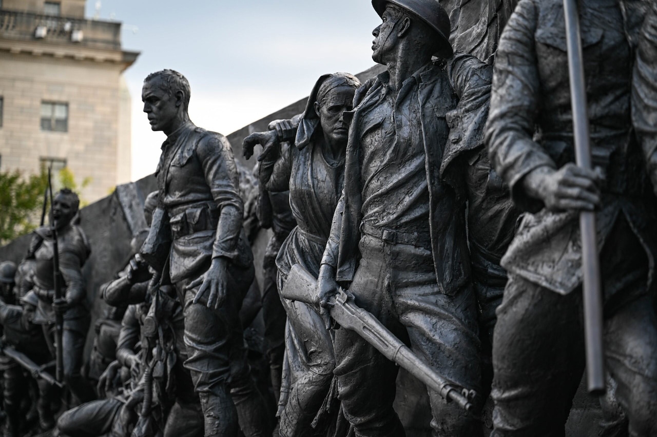 A sculpture depicts scenes from World War I.