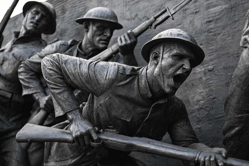 A sculpture depicts scenes from World War I.