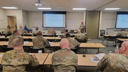 Capt. James Judd, a judge advocate general with the Oklahoma Army National Guard, briefs OKARNG company commanders and first sergeants about what Uniformed Code of Military Justice and Oklahoma Code of Military Justice actions they are authorized to pursue during the 2024 OKARNG Company Commanders and First Sergeants Pre-Command Course at the Norman Armed Forces Reserve Center, Norman, Oklahoma, Sept. 14, 2024. The course reinforces lessons learned at Army-wide leadership courses and mentors the new command teams on OKARNG-specific systems and procedures. (Oklahoma National Guard photo by Anthony Jones)