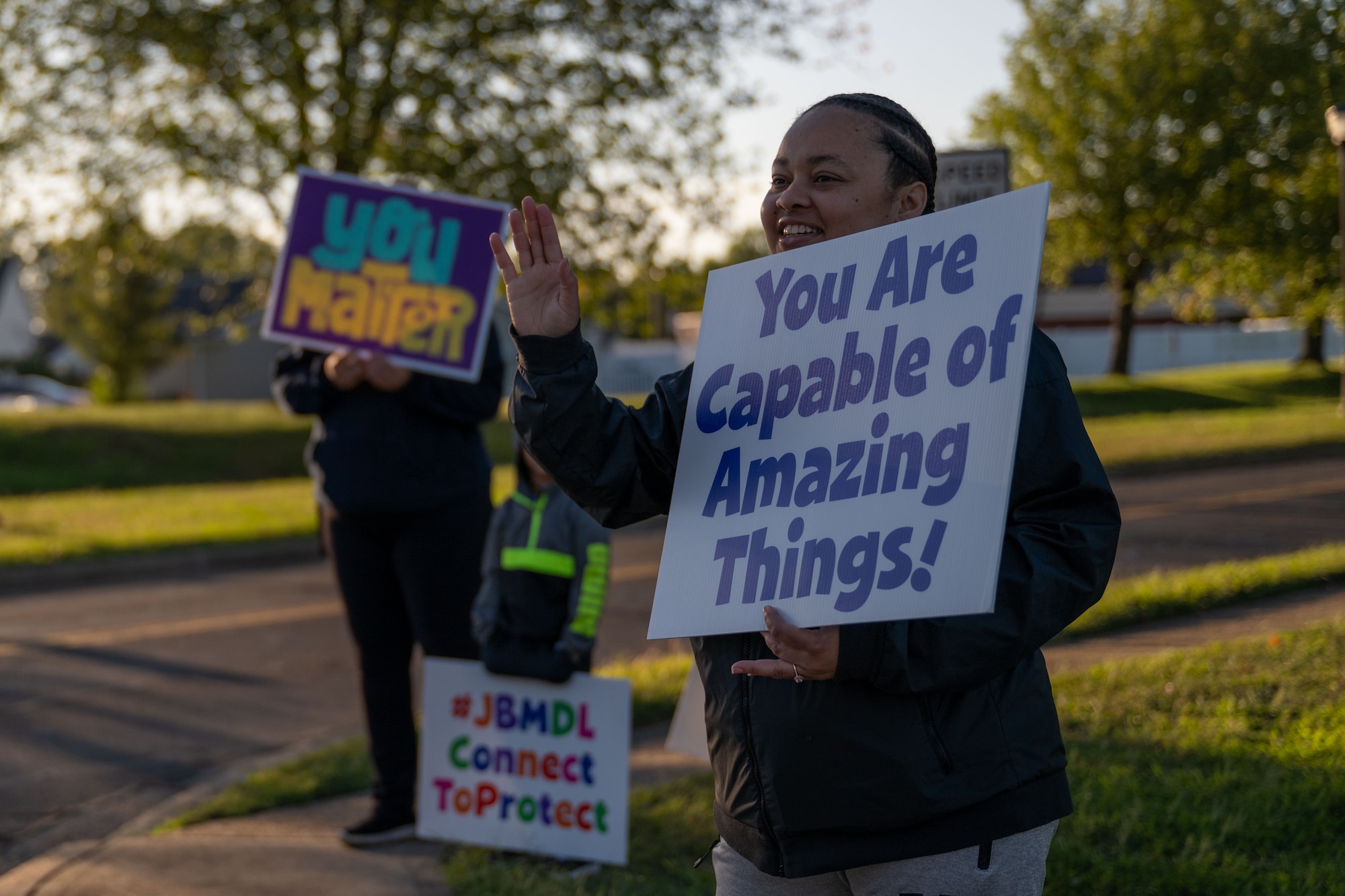 A volunteer holds up an encouraging sign during a National Suicide Prevention Awareness Month event at Joint Base McGuire-Dix-Lakehurst, N.J., Sept. 3, 2024. The month of September is the National Suicide Prevention Awareness Month where many organizations make a concerted effort to destigmatize the mental health struggles that many may face and take the opportunity to educate the public on recognizing signs someone is need of support as well as the avenues to receive support. (U.S. Air Force photo by Staff Sgt. Monica Roybal)