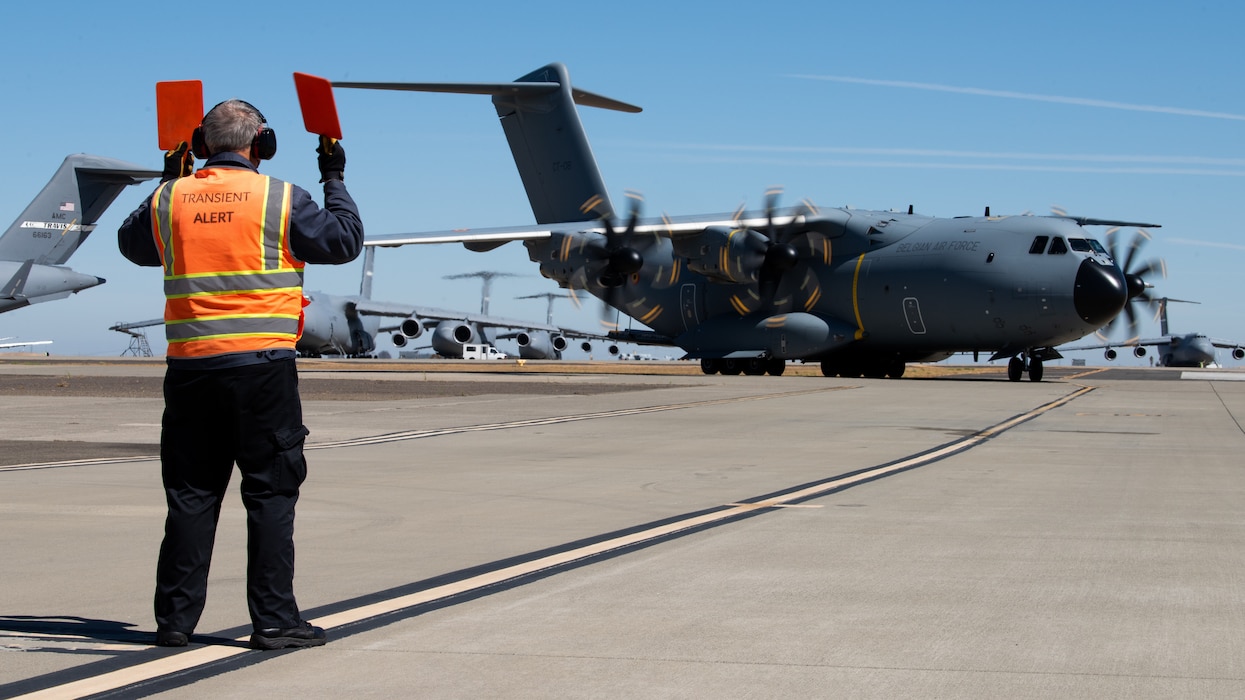 Airman directs foreign aircraft on flight line