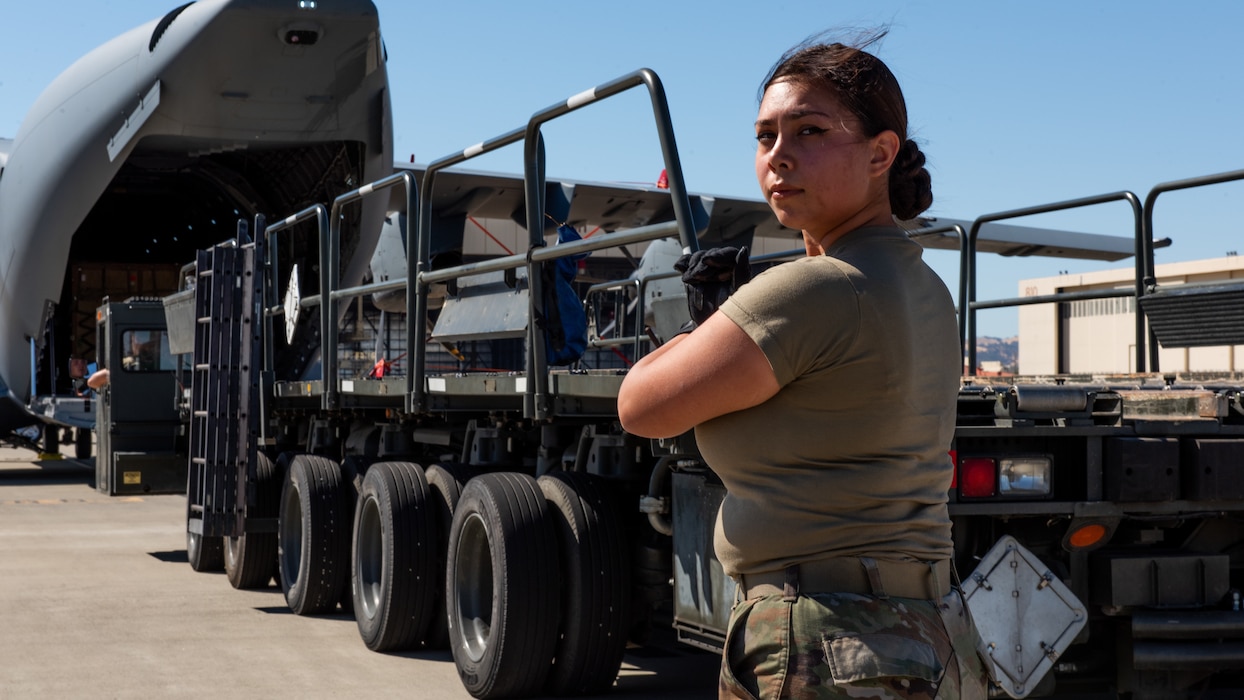 Airmen guides loader on flight line