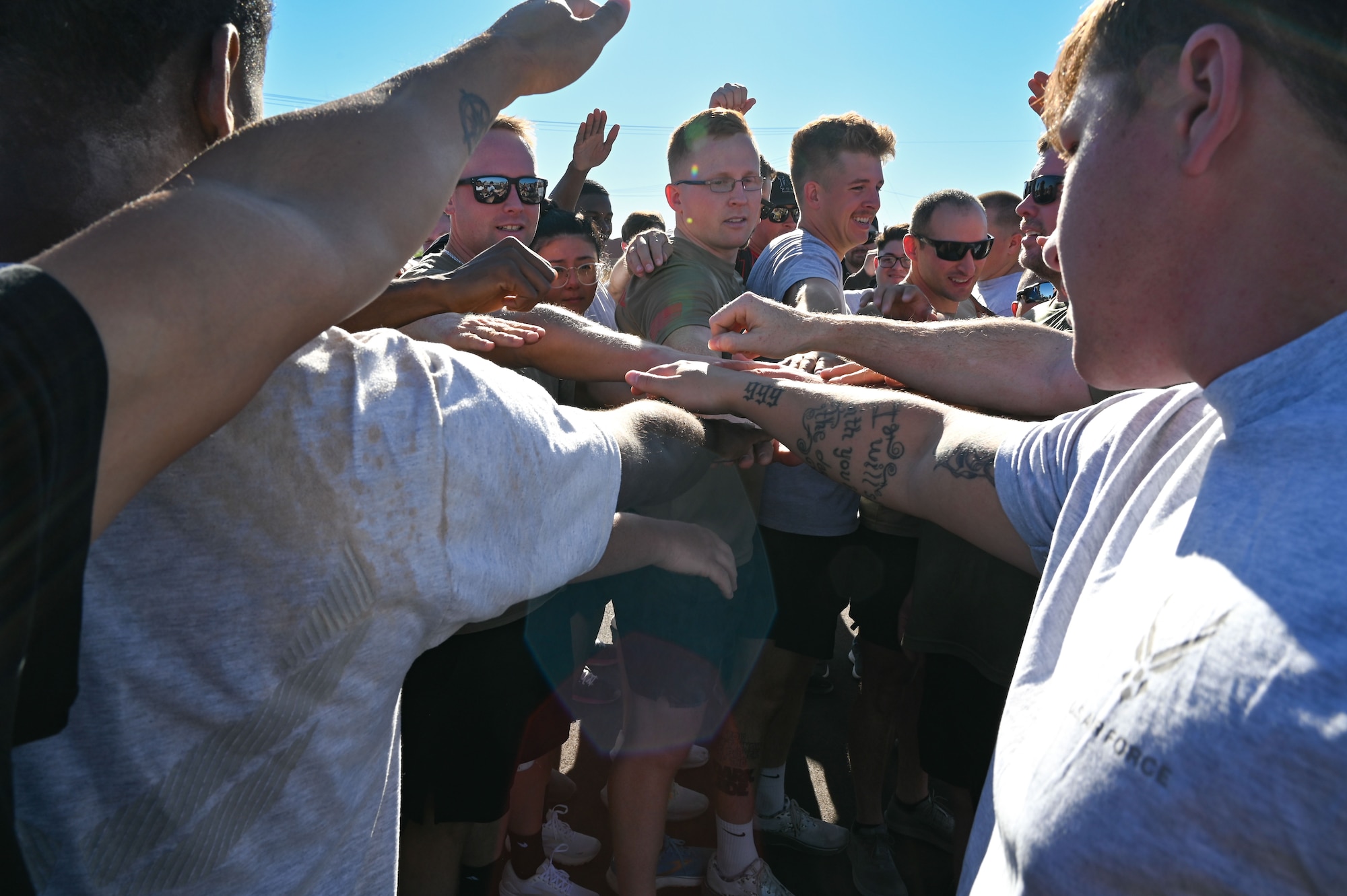 People put their hands together for a chant.