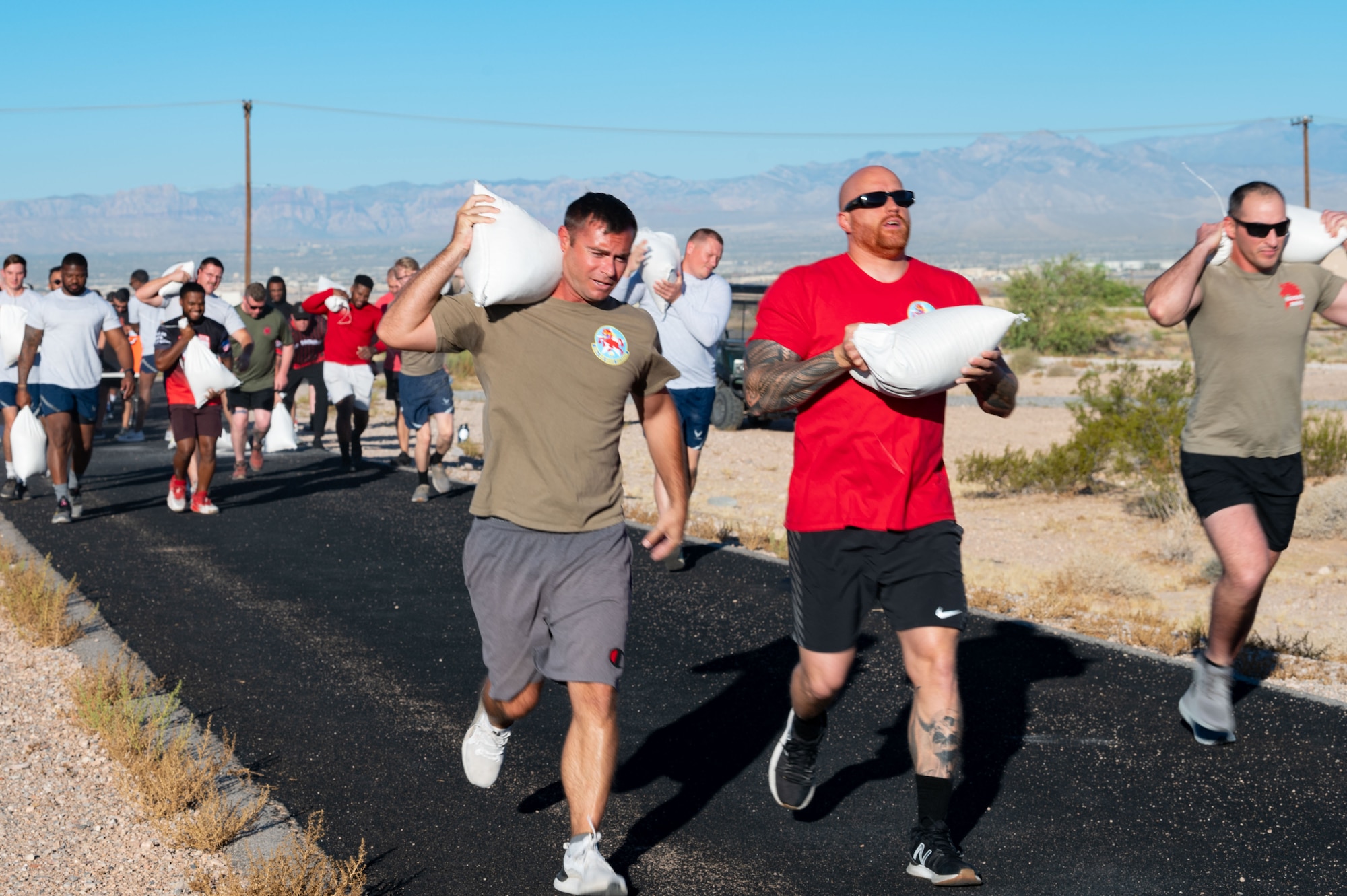 People running with sandbags.