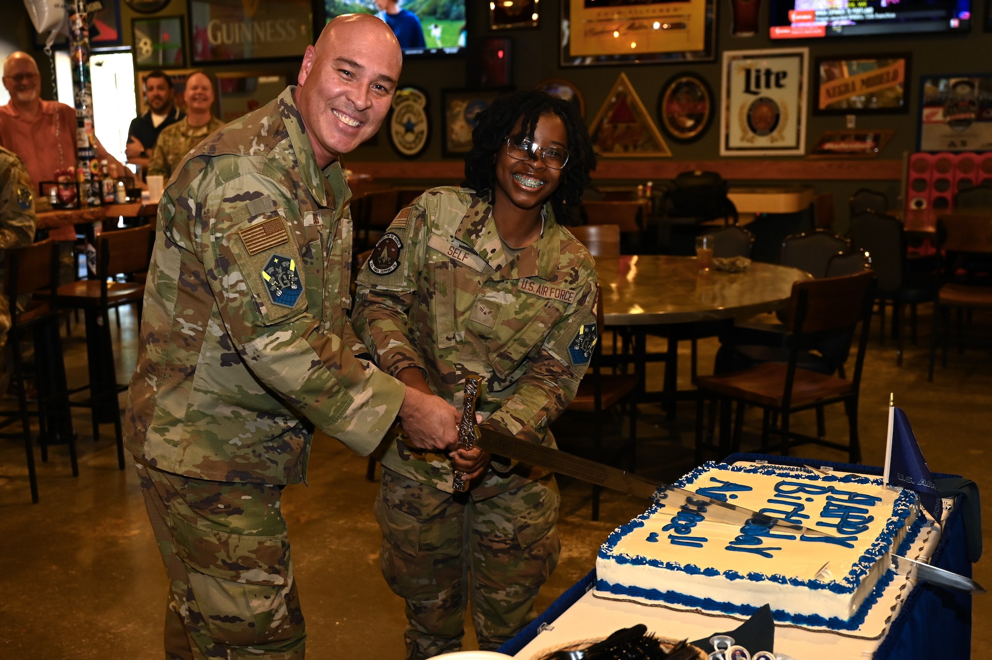 U.S. Space Force Col. David Berríos, Space Base Delta 1 vice commander cuts the cake with A1C Taiya Self, force management technician, at the SBD 1 Air Force Birthday celebration at Peterson Space Force Base, Colorado, Sept. 18, 2024.