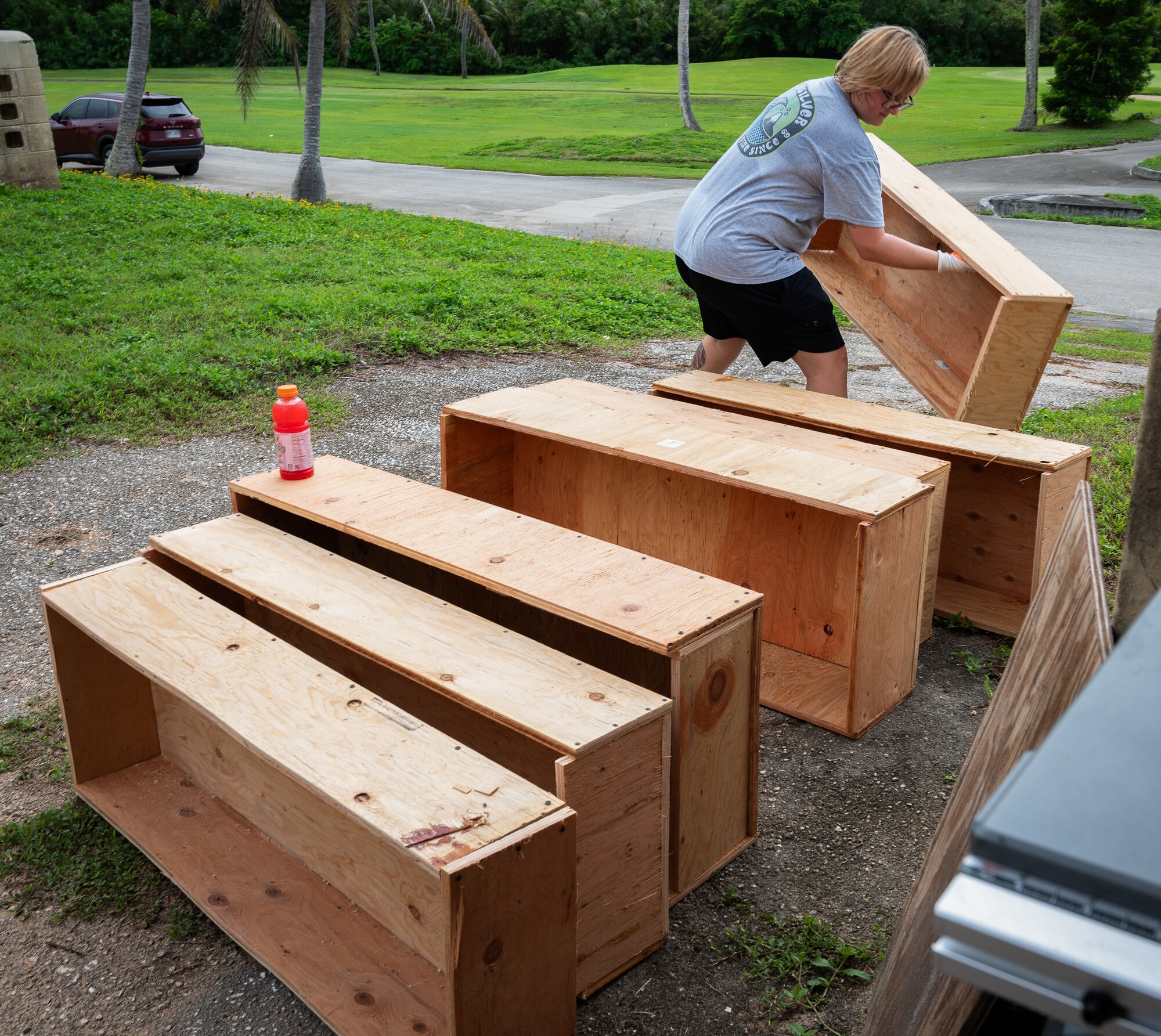 A volunteer adds to the row of completed homemade planter boxes at Andersen Air Force Base, Guam, Sept. 14, 2024. The Andersen Community Garden Initiative has recently gained a lot of interest by both squadrons and residents. Airmen volunteered to help create the many ordered planter boxes that will be given to flights and families so they can start fruit and vegetable gardens around base. (U.S. Air Force photo by Staff Sgt. Pedro Tenorio)