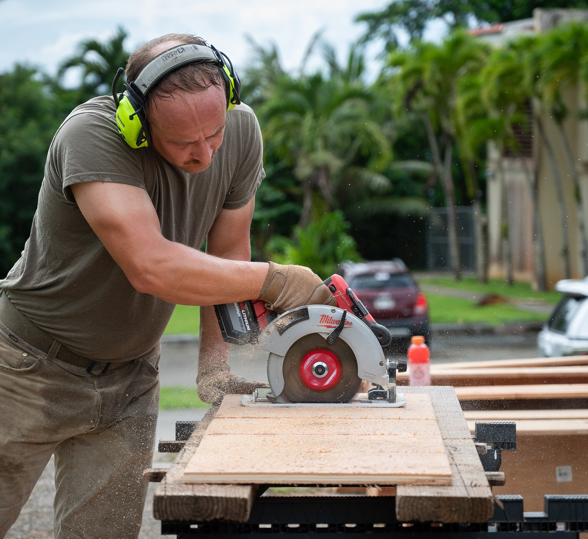 A volunteer cuts wood to be used to create portable planters for the Andersen Community Garden Initiative at Andersen Air Force Base, Guam, Sept. 14, 2024. These portable planters have been ordered in groups by both squadrons and residents on Andersen. The hope of the initiative is to have functioning mini gardens all over base to supplement the main communal one. (U.S. Air Force photo by Staff Sgt. Pedro Tenorio)