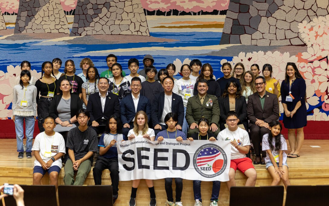 Special guests, students of Matthew C. Perry High School, and local Japanese high school students pose for a group photo during the Student Educational Exchange and Dialogue (SEED) Project 2024-2025 at Marine Corps Air Station Iwakuni, Japan, Sept. 8, 2024. SEED is a youth cultural exchange program organized by Japan’s Ministry of Foreign Affairs and the U.S. Department of Defense Education Activity which allows Japanese and American students to participate in two days of hands-on activities designed to foster diverse perspectives, promote mutual understanding, bridge language barriers, and build problem-solving skills. (U.S. Marine Corps photo by Lance Cpl. Colin Thibault)