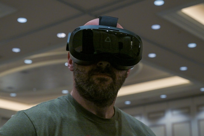A conference attendee wears a VR headset.