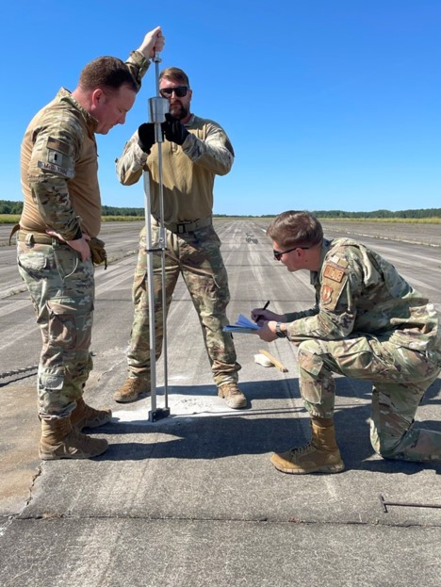 Members of the 435 CRS Survey Team use a Dynamic Cone Penetrometer to determine the underlying soil strength of a Landing Zone. This task is instrumental to determining which aircraft may utilize the LZ and how many times it may be safely used. (U.S. Air Force courtesy photo)