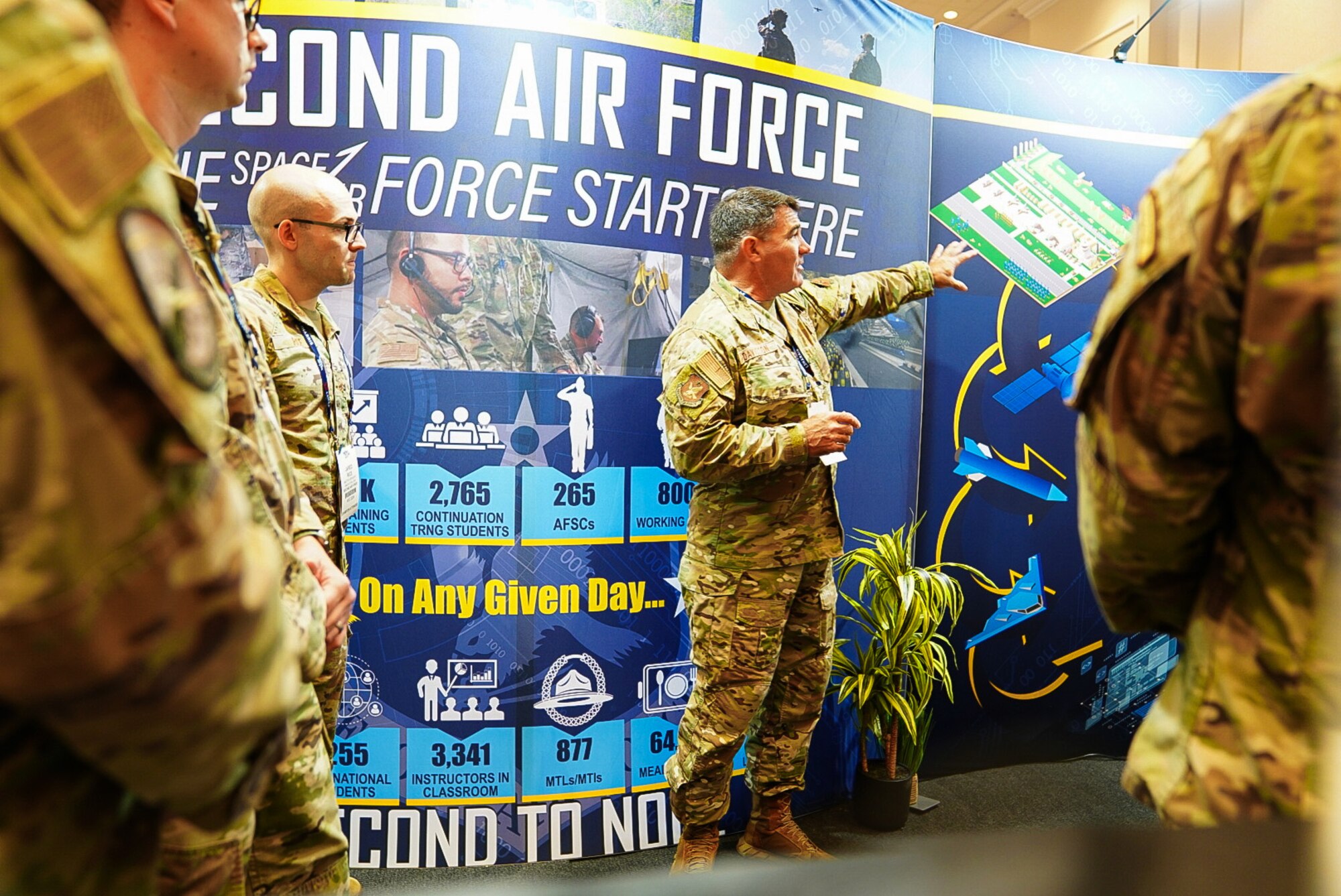 Maj. Gen. Wolfe Davidson, Second Air Force commander, huddles with the Second Air Force exhibit booth leads before the exhibit hall opens at the Air, Space and Cyber Conference, National Harbor, Md., Sept. 16, 2024.