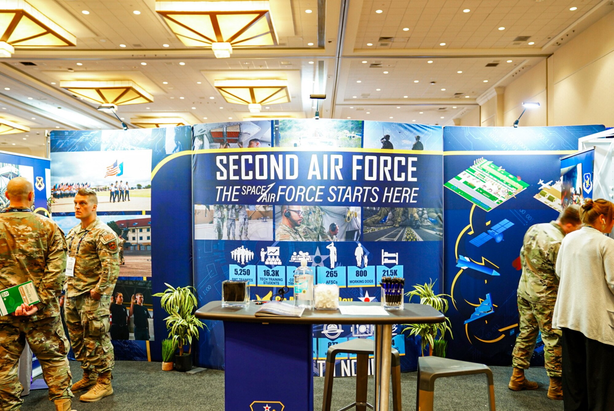 Second Air Force presenters prepare for a full day in the exhibit hall at the Air, Space and Cyber Conference in National Harbor, Md., Sept 16, 2024.
