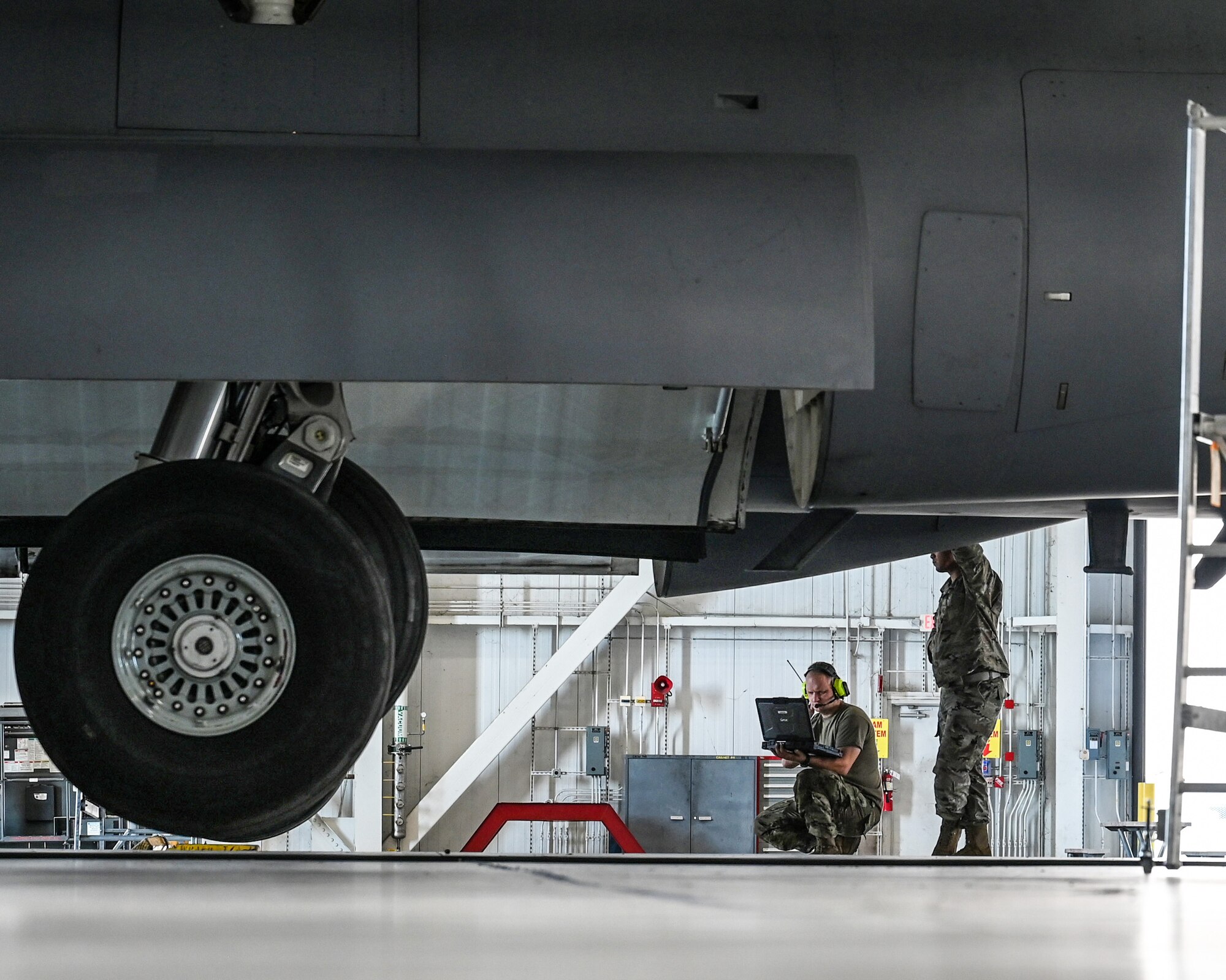 Master Sgt. Michael Kessinger, left, 445th Aircraft Maintenance Squadron aircraft mechanic, and Master Sgt. Michael Wilson, 445th AMXS crew chief, inspect a gear swing on the underbelly of a C-17 Globemaster III during the Sept. 15, 2024 unit training assembly.