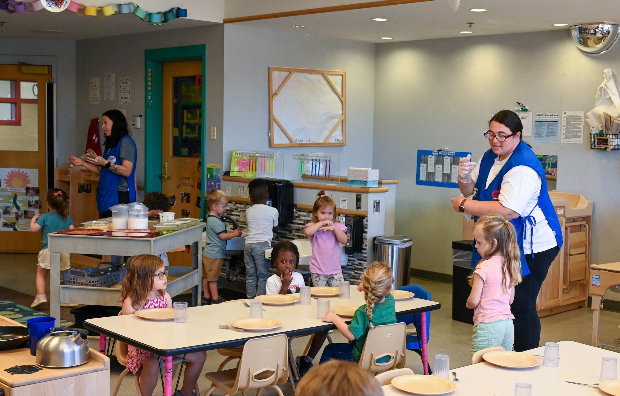 Stephanie Gray, 97th Force Support Squadron Child Development Center program lead teacher, prepares to serve lunch to her students at the CDC on Altus Air Force Base, Oklahoma, Sept. 7, 2024. Mrs. Stephanie Gray is the lead program teacher for children ages three to five. (U.S. Air Force photo by Airman 1st Class Heidi Bucins)