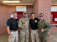Four service members pose for a photo.