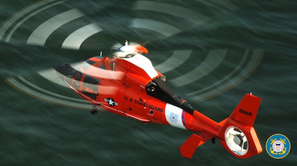 An HH65C model helicopter from Air Station Atlantic City flys low over the Atlantic Ocean. The newly re-engined helicopters are part of the Coast Guard's Deepwater program. Photo by PA2 John Edwards.