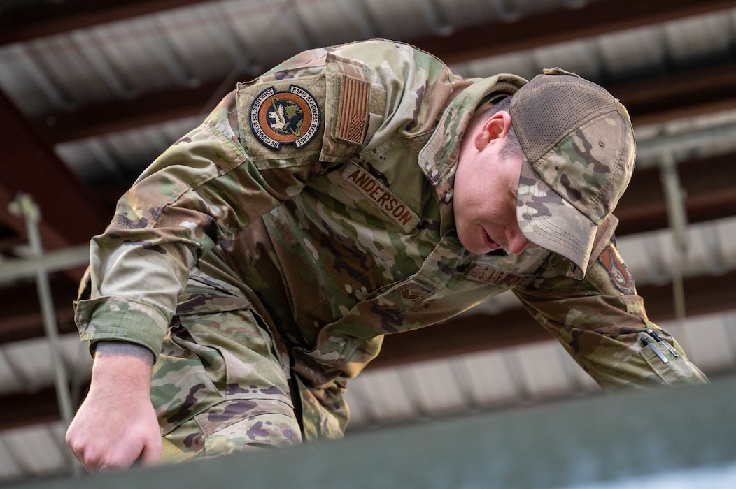 U.S. Air Force Senior Airman Austin Anderson, 354th Logistics Readiness Squadron fuels distribution supervisor and fixed facilities technician, inspects the fuel level through a viewing hole on the top of the fuel tank of an R11 aircraft refueling vehicle at North Pole, Alaska, Sept. 13, 2024.