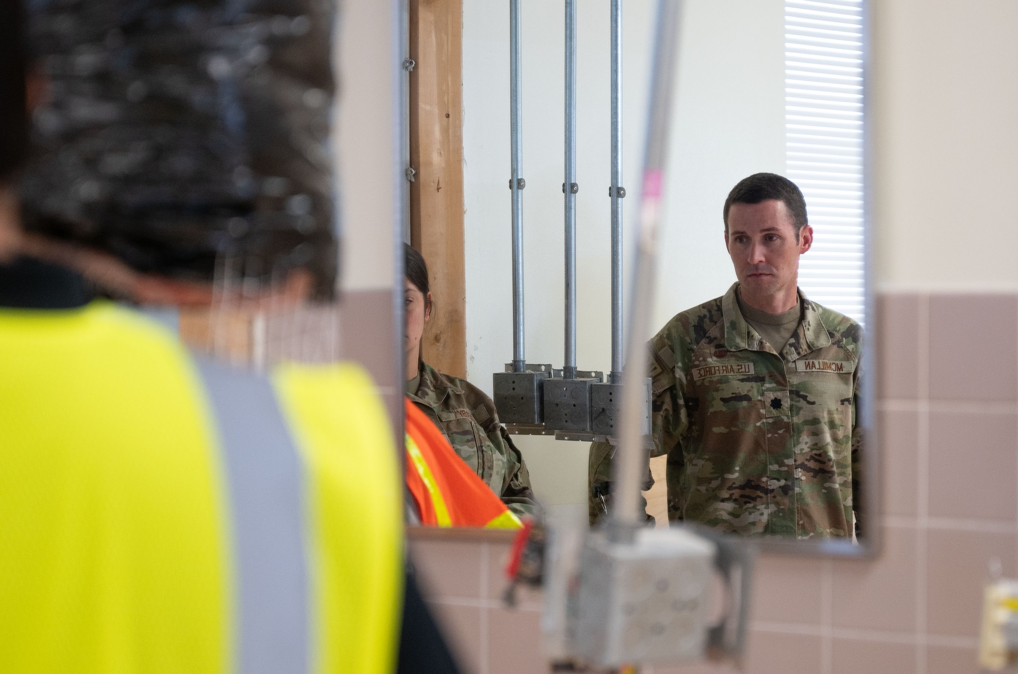 U.S. Air Force Lt. Col. Micah McMillan, 436th Airlift Wing Judge Advocate, staff judge advocate, looks on as Team Dover members from the 436th Contracting Squadron and the 436th Civil Engineering Squadron discuss the renovation for the courtroom at the Law Center at Dover Air Force Base, Delaware, Sept. 5, 2024. The courtroom renovation is one of many projects the 436th CONS is invested in, displaying its role in assisting base functions. (U.S. Air Force photo by Airman Liberty Matthews)