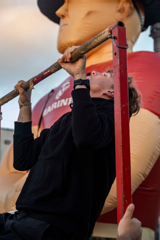 Point Loma High School students participate in a pull-up challenge during a military appreciation night at Point Loma High School in San Diego, Aug. 23, 2024. The military appreciation night was held to honor military service members and foster community connections. (U.S. Marine Corps photo by Staff Sgt. Jesula Jeanlouis)