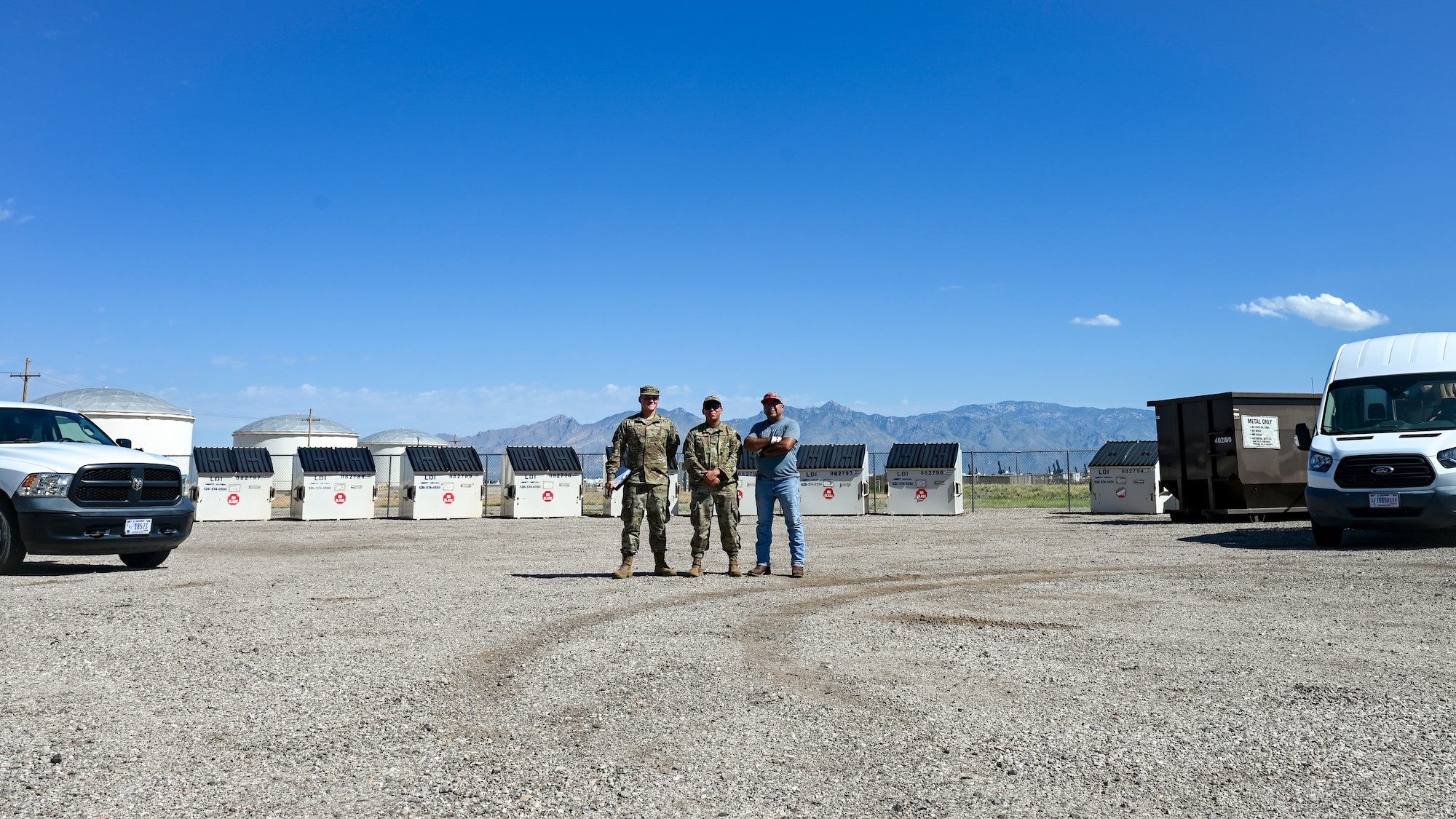 U.S. Airmen from 355th Civil Engineering Squadron, who operate the recycling center stand in front of bins, Aug. 29, 2024, at Davis-Monthan Air Force Base, Arizona. The recycling center is open from 0900 to 1200 on Tuesdays and Thursdays. (U.S. Air Force photo by Senior Airman Katelynn Kennedy)