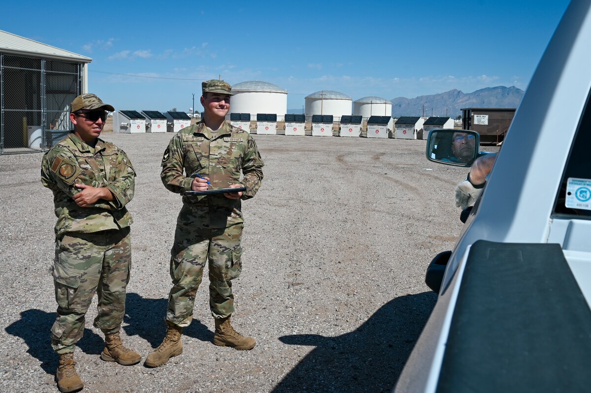 U.S. Air Force Staff Sgt. Arturo Rosales, 355th Civil Engineer Squadron non-commissioned officer in charge of work management, left, and Airman Wyatt Steel Dale Operations Manager stand at the ready to check in customer’s recycling material, Aug. 29, 2024, at Davis-Monthan Air Force Base, Arizona. Personnel at the recycling center guide customers to recycle material properly in order to maximize diversion of refuse from landfills. (U.S. Air Force photo by Senior Airman Katelynn Kennedy)