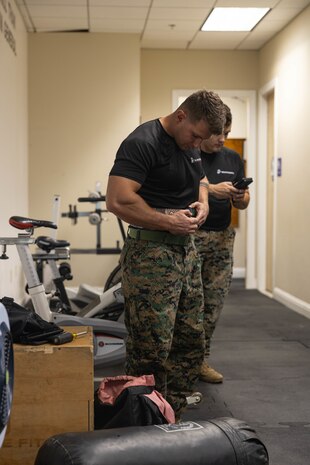 U.S. Marine Corps Staff Sgt. Preston Brandes, a canvassing recruiter with Recruiting Station Sacramento, fastens his weightlifting belt in a weightlifting competition in Sacramento, Calif., Aug. 27, 2024. Swole Mode was created to test the physical strength and endurance of Marines stationed at RS Sacramento and to build unit cohesion and Esprit de Corps. (U.S. Marine Corps photo by Sgt. Ryan Harvey)