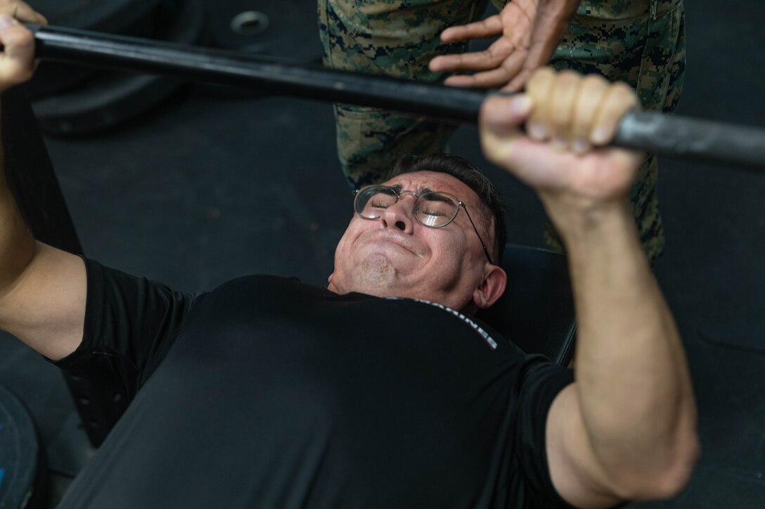 U.S. Marine Corps Sgt. Andrew Cortez, a canvassing recruiter with Recruiting Station Sacramento, benches in a weightlifting competition in Sacramento, Calif., Aug. 27, 2024. Swole Mode was created to test the physical strength and endurance of Marines stationed at RS Sacramento and to build unit cohesion and Esprit de Corps. (U.S. Marine Corps photo by Sgt. Ryan Harvey)