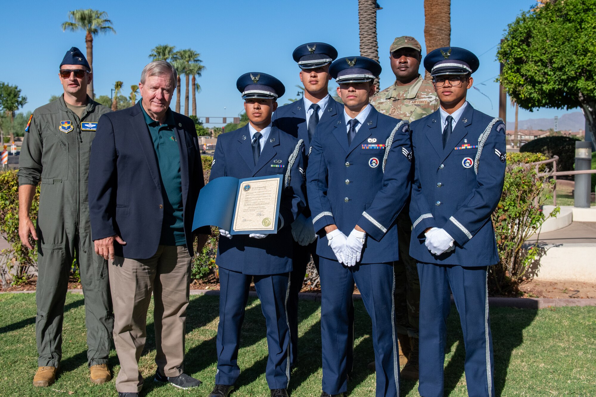 U.S. Air Force Lt. Col. Matthew Johnston, 56th Fighter Wing deputy commander (left), Thomas Schoaf, Litchfield Park mayor, Chief Master Sgt. Quentin Davis, 56th Medical Group senior enlisted leader (back right), and the Luke Air Force Base Honor Guard pose for a photo at Litchfield Park City Hall to commemorate the Air Force’s 77th birthday, Sept. 18, 2024, in Litchfield Park, Arizona.