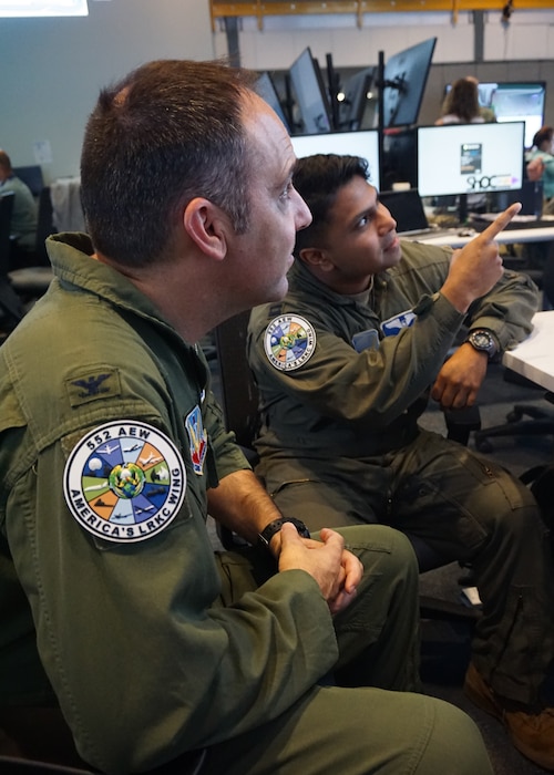 Col. Jason Zemler, 552nd Operations Group commander and Bamboo Eagle 552d Air Expeditionary Wing commander, and Capt. Salam Abu, BE white force participant look at a computer screen