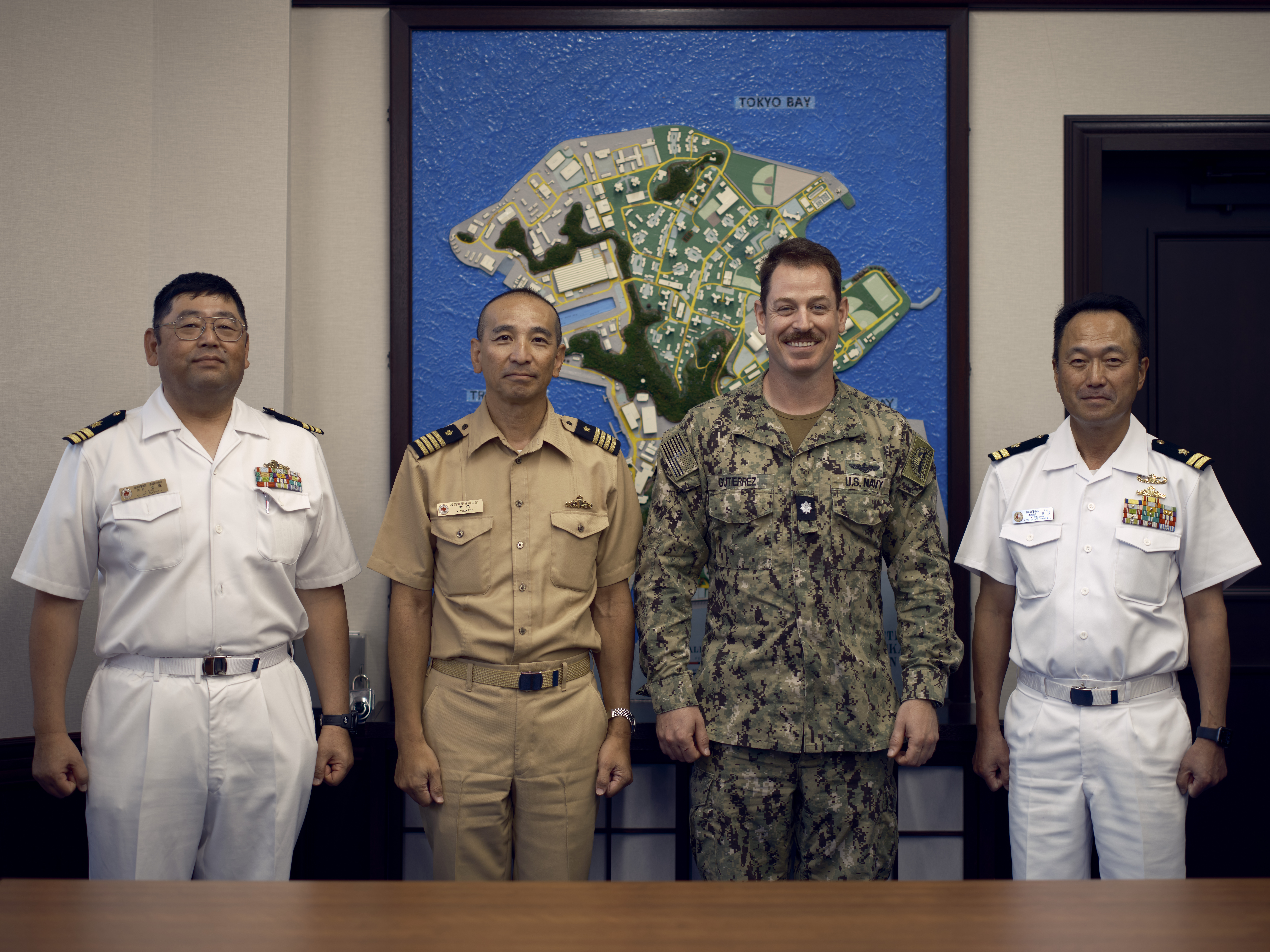 Japan Maritime Self-Defense Force Capt. Hisachika Yoshida, Commanding Officer, Area Guard Group Yokosuka, (center)and his staff officers visit Commander, Fleet Activities Yokosuka's Chief Staff Officer, Cmdr. Patrick Gutierrez, September 12, 2024.
