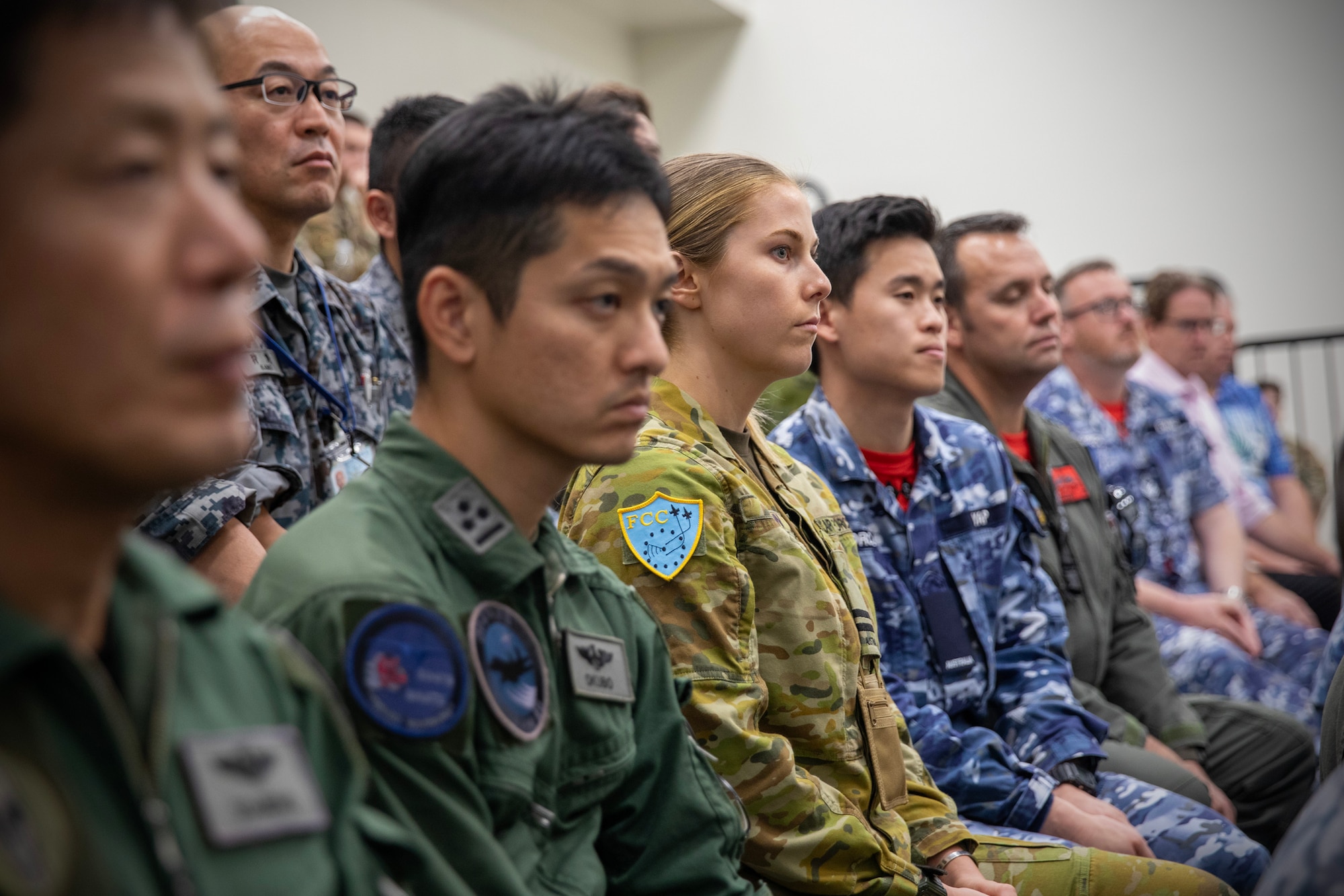 Far East Tactics Analysis Team conference attendees listen a speech during the conference at Yokota Air Base, Japan, Sept. 13, 2024. The FETAT conference is an annual event that brings together operators and intelligence professionals from around the world to collaborate on information related to adversary air tactics, techniques, and procedures. This is the first year that representatives from Japan and Five Eyes (FVEY) partners, including Australia, Canada, New Zealand, and the United Kingdom participated. (U.S. Air Force photo by Yasuo Osakabe)