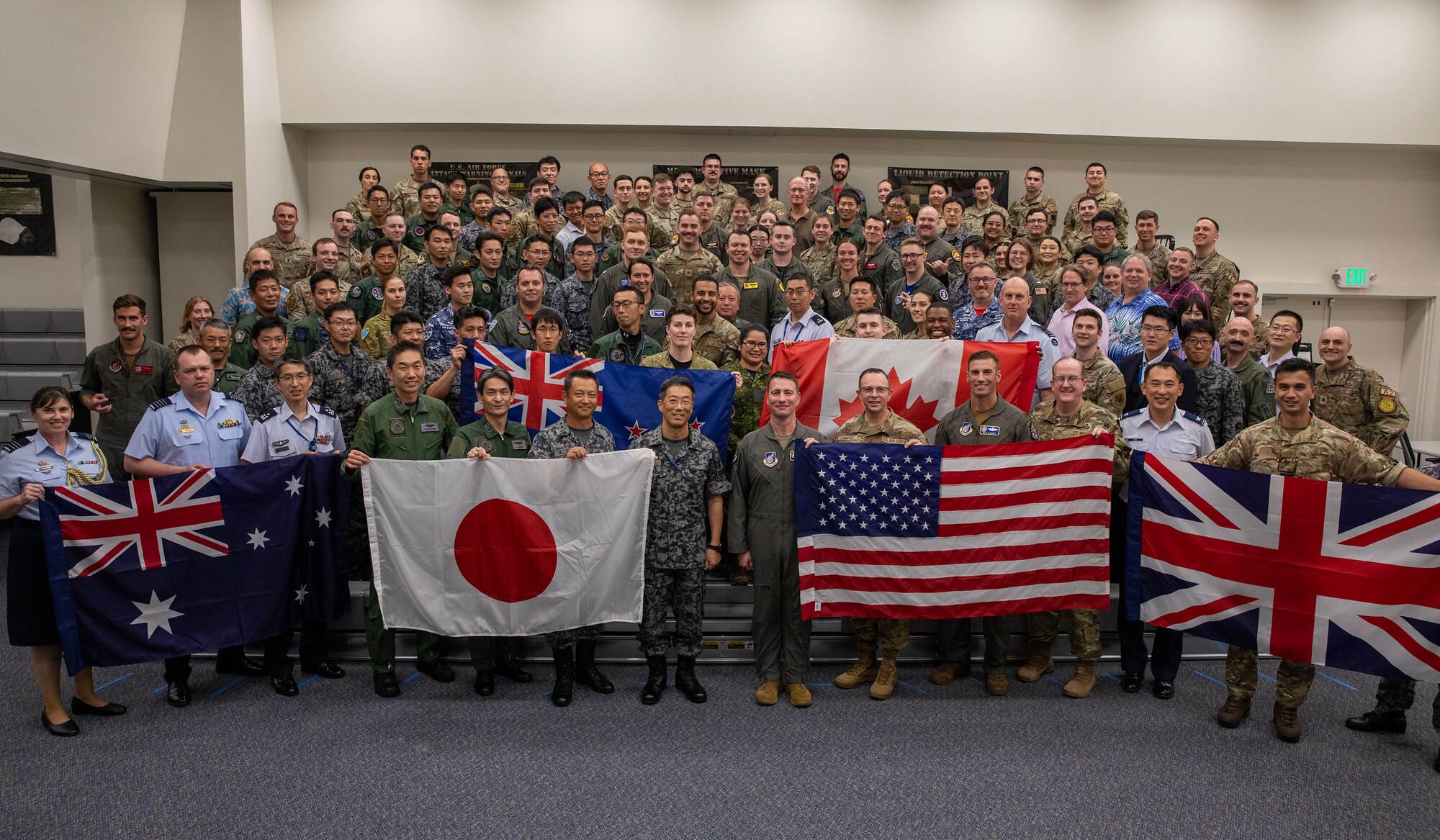 Far East Tactics Analysis Team conference attendees pose for a photo after the conference at Yokota Air Base, Japan, Sept. 13, 2024. The FETAT conference is an annual event that brings together operators and intelligence professionals from around the world to collaborate on information related to adversary air tactics, techniques, and procedures. This is the first year that representatives from Japan and Five Eyes (FVEY) partners, including Australia, Canada, New Zealand, and the United Kingdom participated. (U.S. Air Force photo by Yasuo Osakabe)