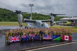 Service members from the United States, Australia, New Zealand, Canada, United Kingdom, Republic of Korea, Japan, and Royal Solomon Islands Police Force, pose for a photo in front of a U.S. Marine Corps MV-22B Osprey assigned to Marine Medium Tiltrotor Squadron 268 (Reinforced), Marine Rotational Force – Darwin 24.3, during Operation Render Safe 2024-2 at Munda International Airport, New Georgia, Solomon Islands, Sept. 13, 2024.