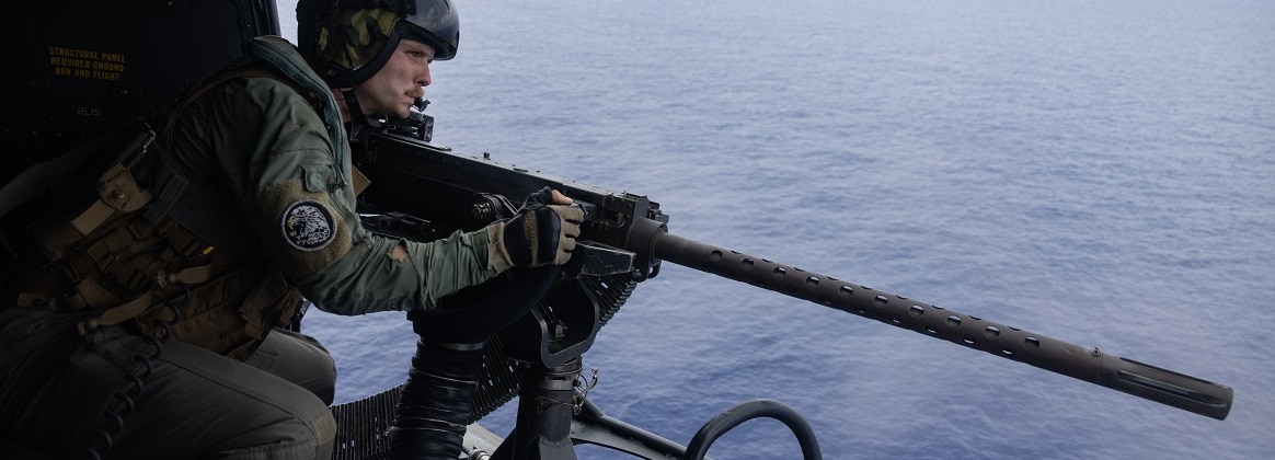 U.S. Marine Corps Sgt. Joshua Flaugher, a UH-1Y Venom crew chief with Marine Medium Tiltrotor Squadron 262 (Rein.), 31st Marine Expeditionary Unit, shoots a M2 .50-caliber machine gun during defense of the amphibious task force live-fire exercise in the Philippine Sea, Sept. 18, 2024.